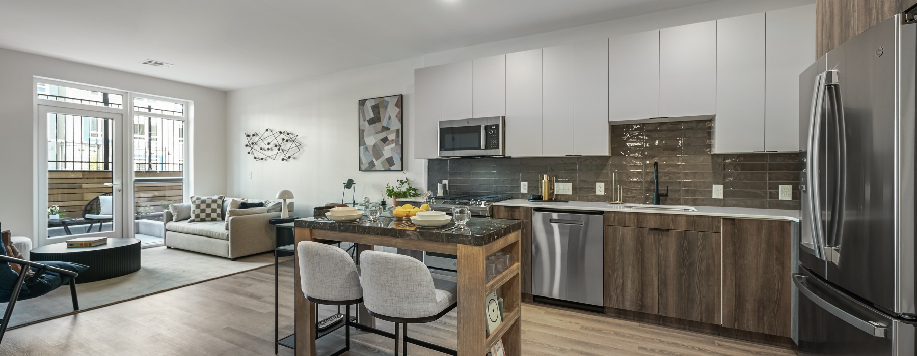 Spacious kitchen with two-tone cabinetry and stainless steel appliances. 