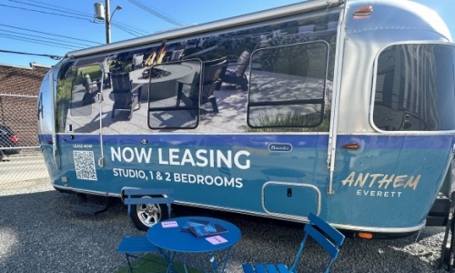 Leasing trailer with table and chairs set up outside
